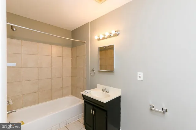 a bathroom with a bathtub a sink and a shower