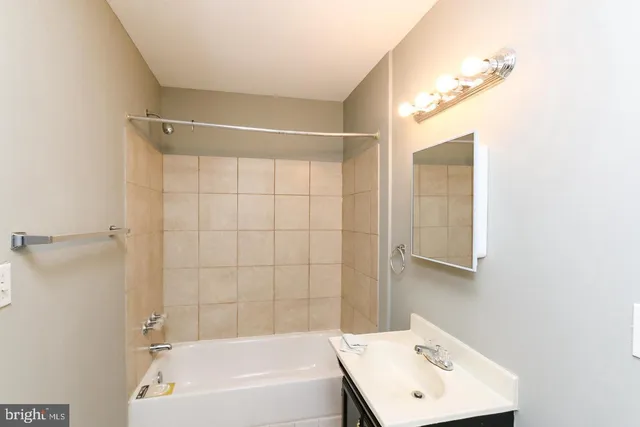 a bathroom with a toilet sink vanity and window