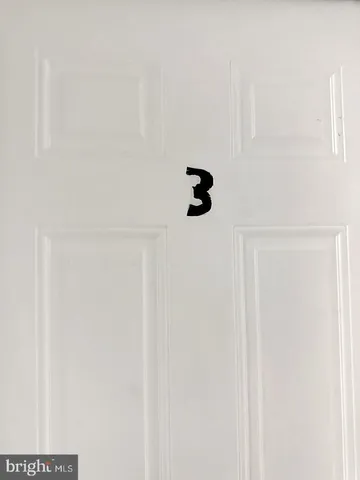 a utility room with wooden floor washer and dryer