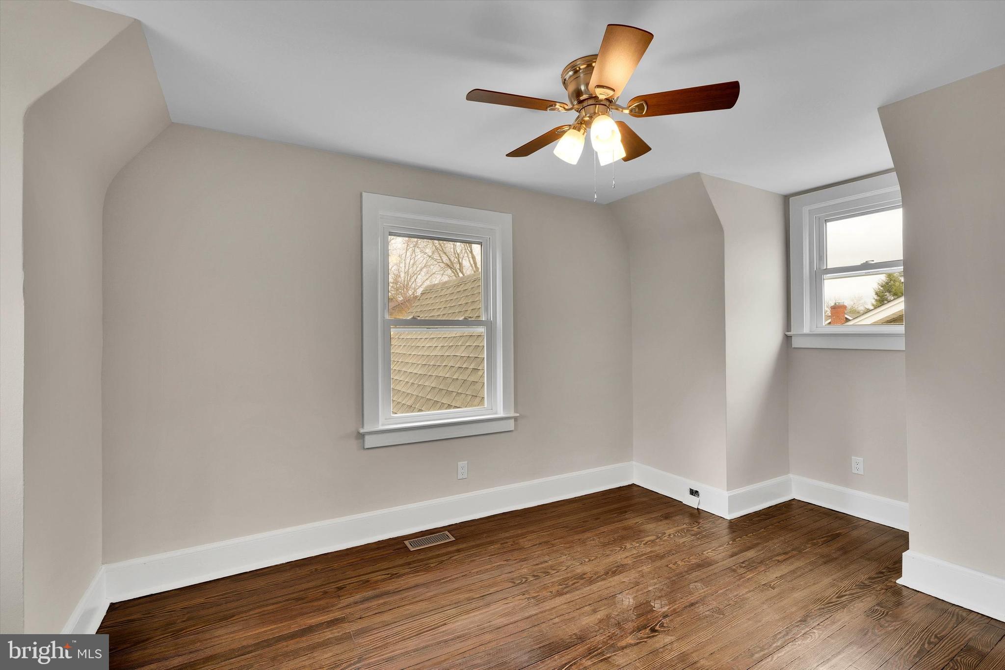 330 Hazel Avenue Delanco, NJ 08075 - Photo 37 of 54 an empty room with wooden floor fan and windows