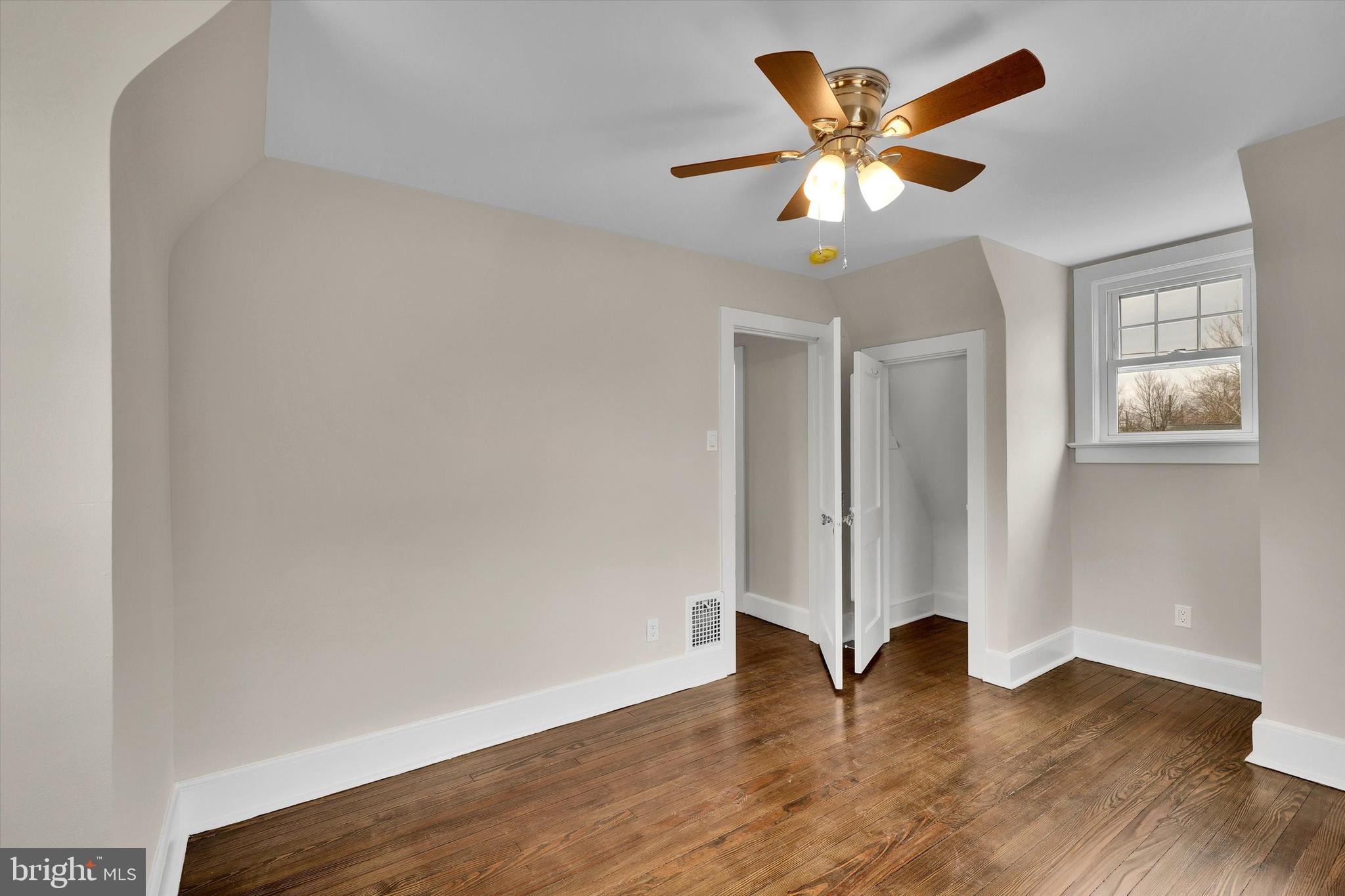 330 Hazel Avenue Delanco, NJ 08075 - Photo 39 of 54 an empty room with wooden floor and windows