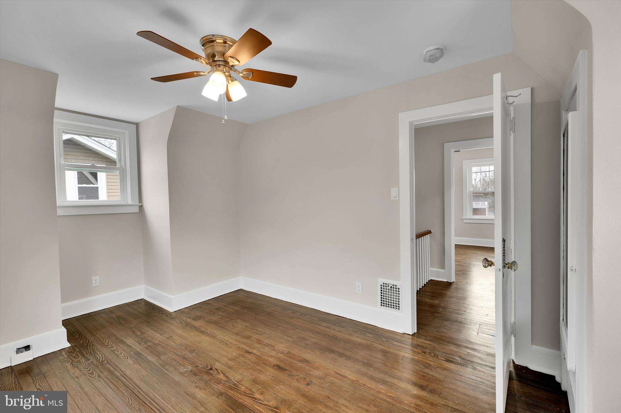 330 Hazel Avenue Delanco, NJ 08075 - Photo 40 of 54 an empty room with wooden floor and a ceiling fan