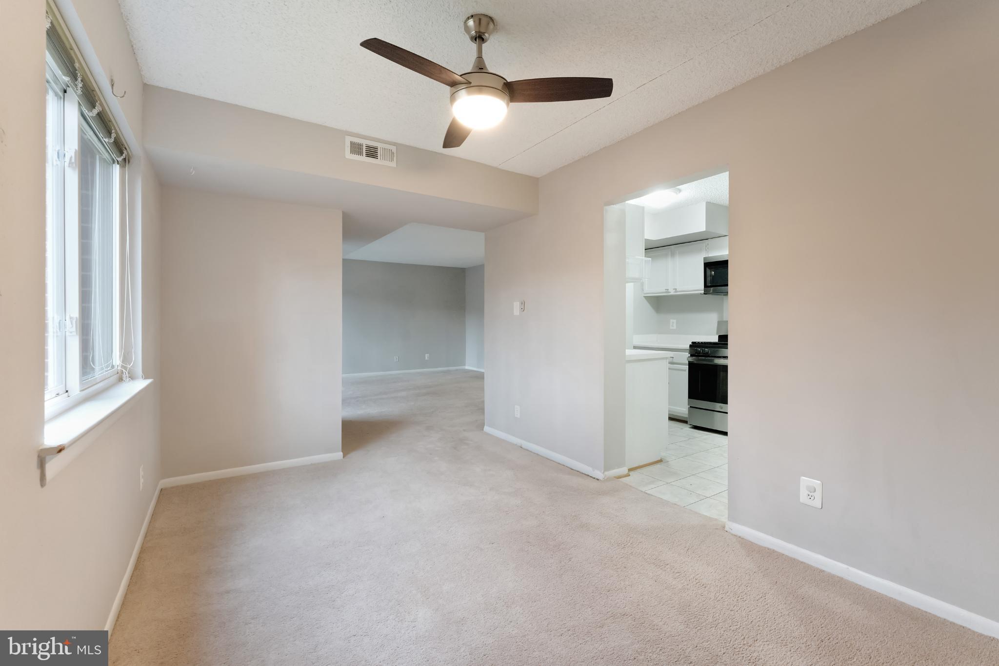 11833 Shire Court, Unit 11B Reston, VA 20191 - Photo 12 of 29 an empty room with windows and fan