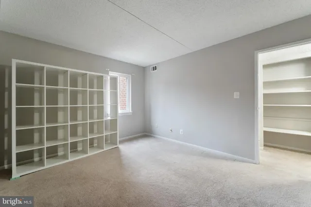 a view of an empty room with empty shelves