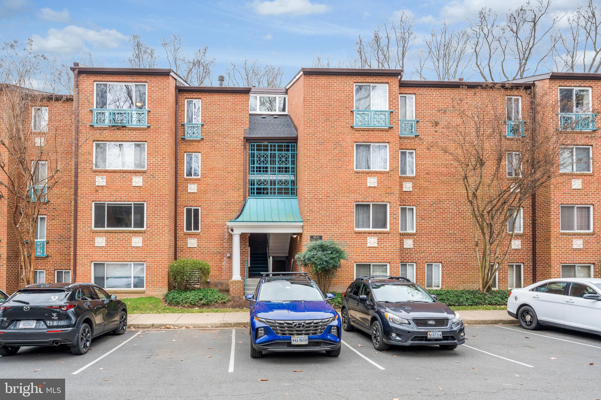 11833 Shire Court, Unit 11B Reston, VA 20191 - Photo 28 of 29 a car parked in front of a building