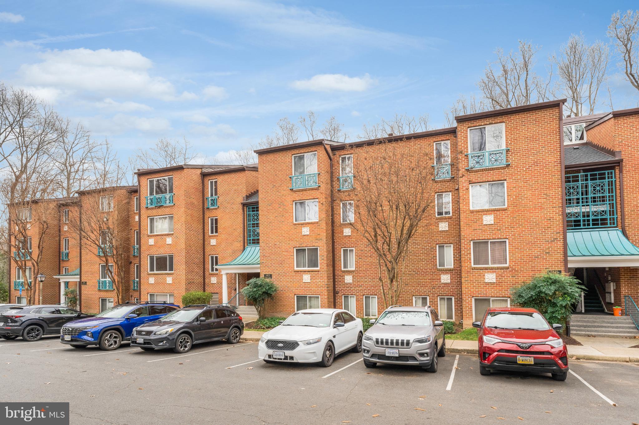 11833 Shire Court, Unit 11B Reston, VA 20191 - Photo 29 of 29 a cars parked in front of a building