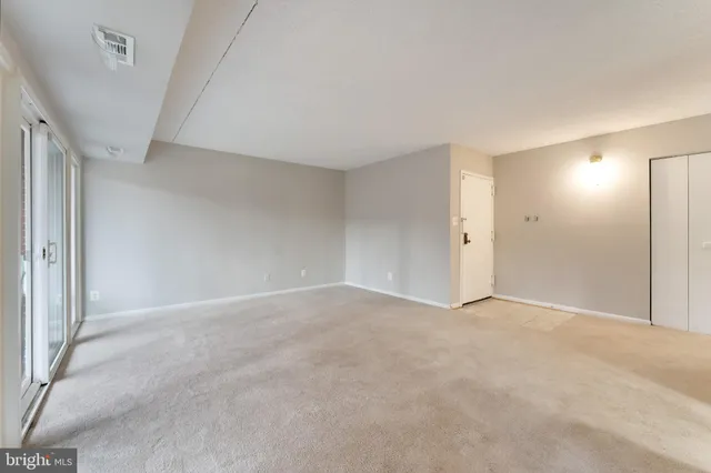a view of an empty room and a window