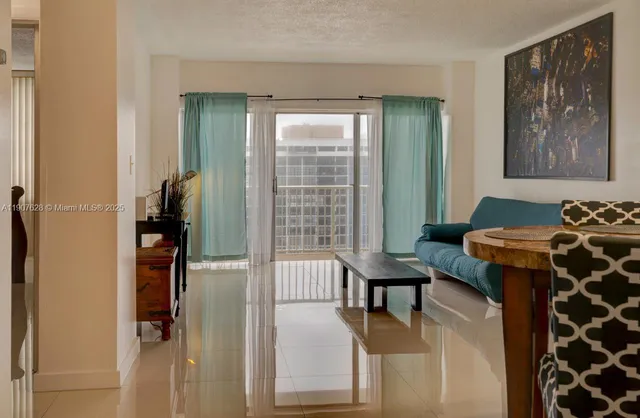 a view of a house with a yard and potted plants