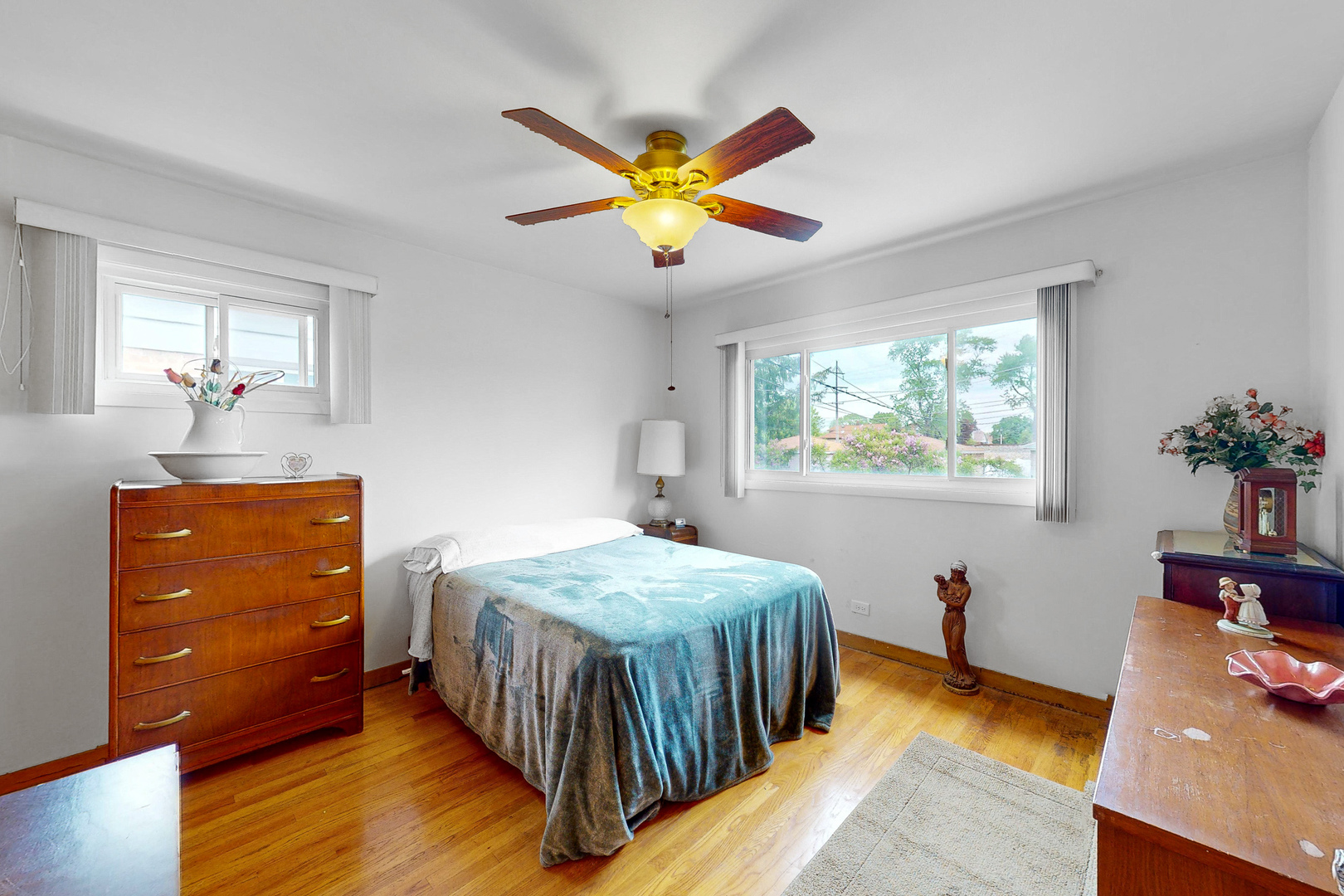 6923 29th Street Berwyn, IL 60402 - Photo 7 of 23 a bedroom with a bed and a chandelier