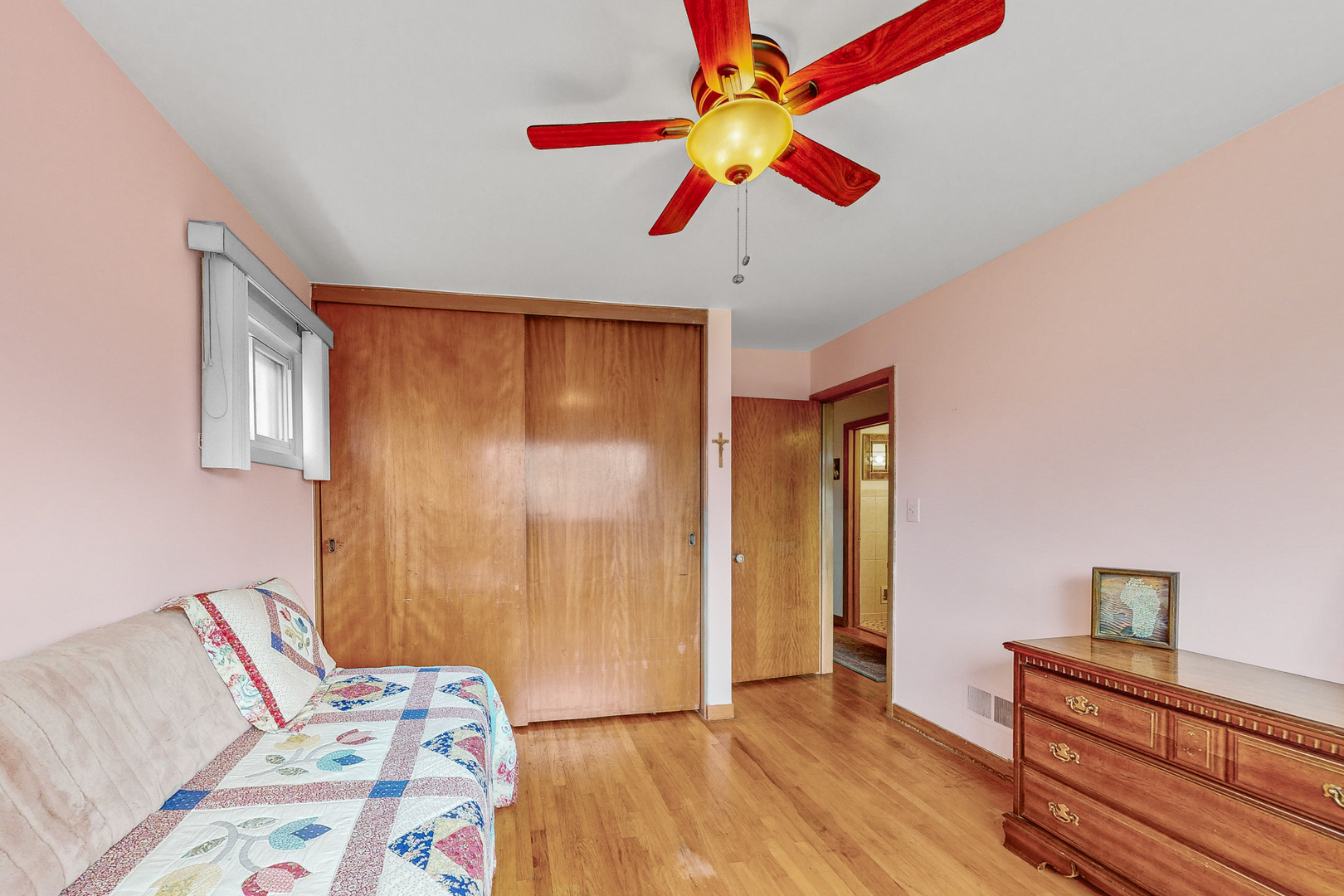 6923 29th Street Berwyn, IL 60402 - Photo 10 of 23 a bedroom with a bed and a chandelier