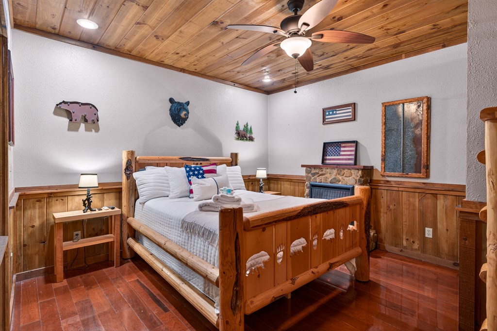 40 Adelaide Trail Blue Ridge, GA 30513 - Photo 24 of 32 a bedroom with a bed and a chandelier