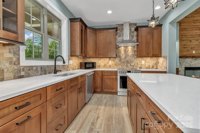 a kitchen with kitchen island granite countertop a sink appliances cabinets and a counter top space