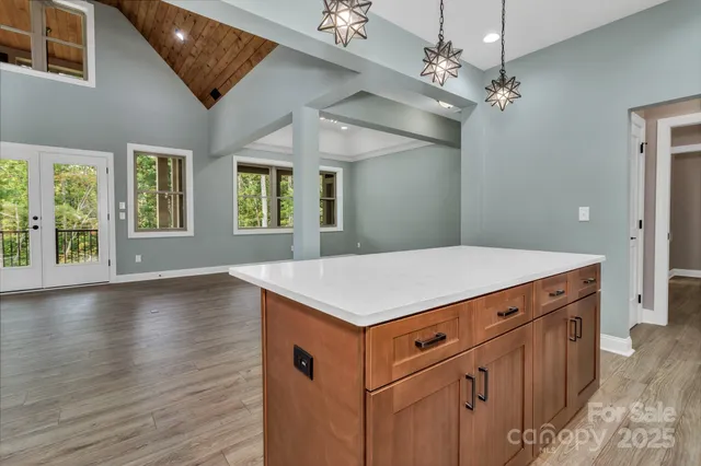 a kitchen with a stove cabinets and wooden floor