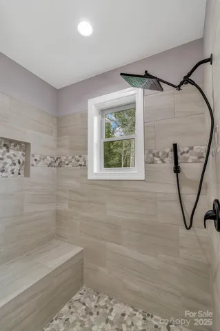 a bathroom with a shower and a window