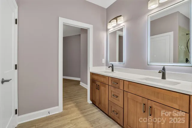 a spacious bathroom with double sink and a mirror