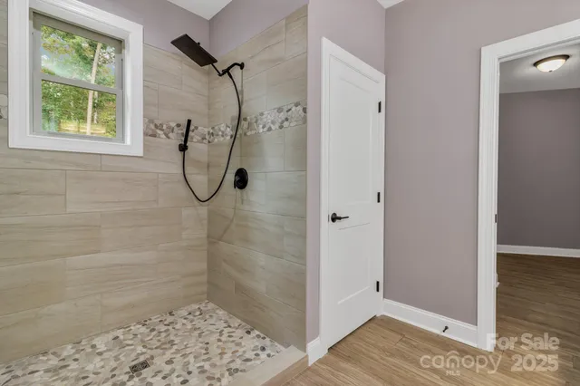 a bathroom with a glass shower door