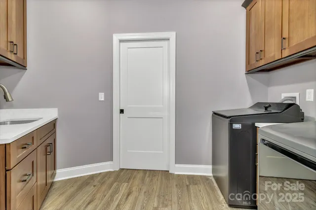 a kitchen with granite countertop white cabinets and black appliances