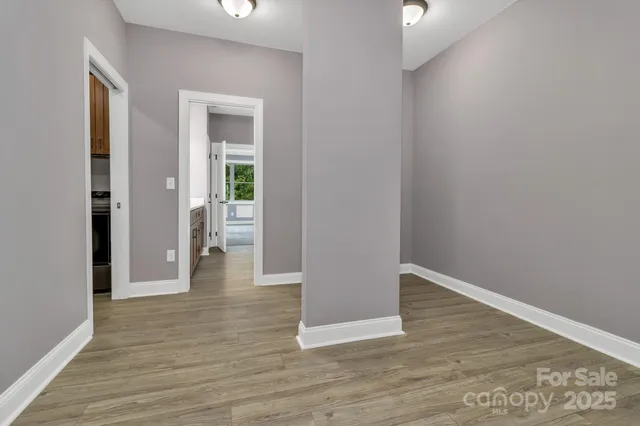 a view of a hallway with wooden floor