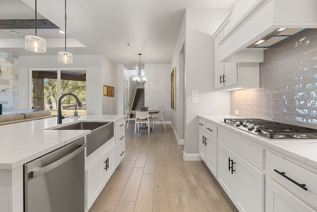 1006 Woodpark Lane Georgetown, TX 78633 - Photo 11 of 27 a kitchen with white cabinets and appliances
