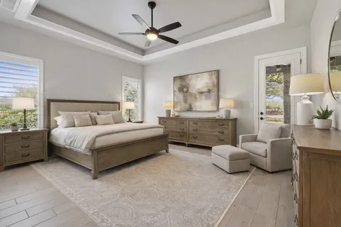 a bedroom with furniture and a large window