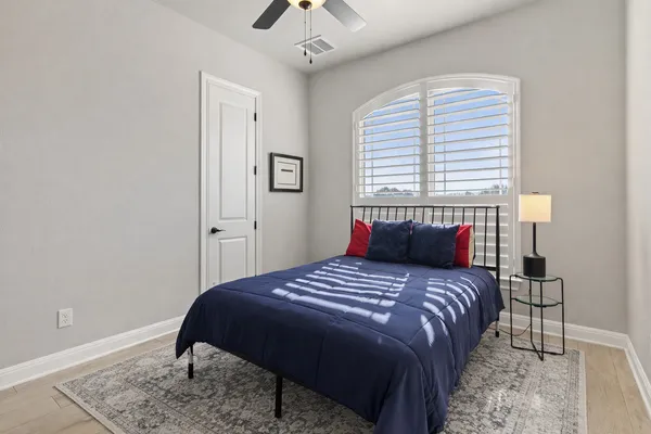 a bedroom with a bed and a window