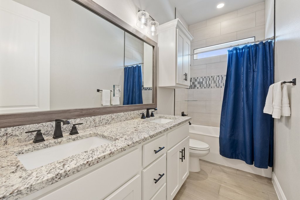 1006 Woodpark Lane Georgetown, TX 78633 - Photo 19 of 27 a bathroom with a granite countertop sink and a mirror