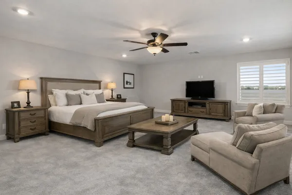 a bedroom with furniture and a flat screen tv