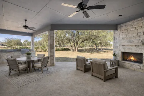 a living room with fireplace furniture and a large window