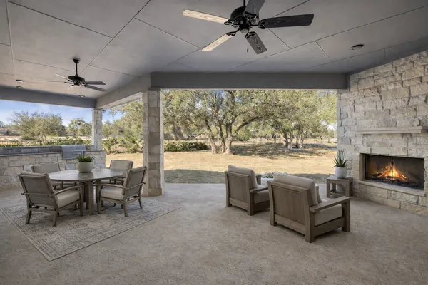 a living room with fireplace furniture and a large window