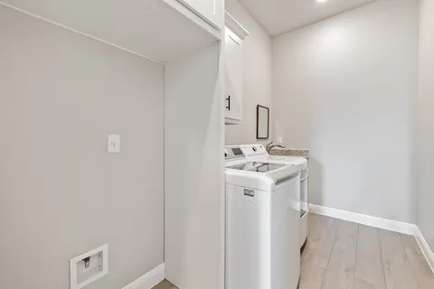 a utility room with a sink dryer and washer
