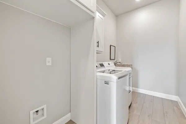 a utility room with a sink dryer and washer