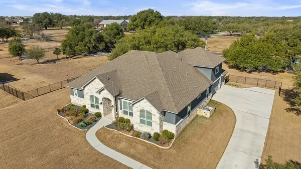 an aerial view of a house with a yard