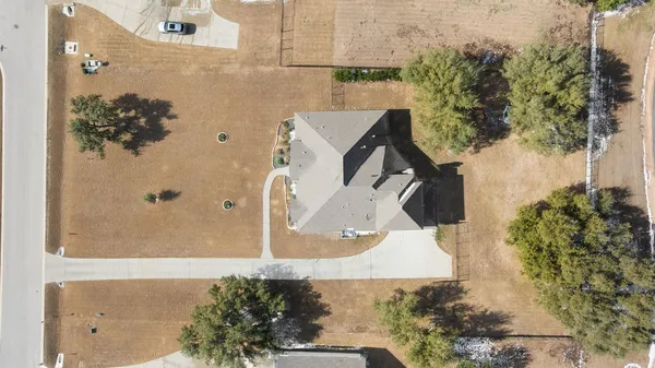 an aerial view of a house with a yard