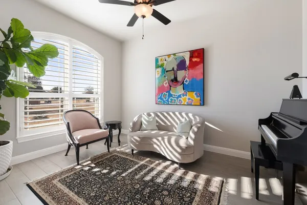 a living room with furniture and a potted plant