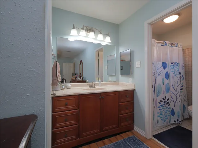 a bathroom with a double vanity sink and a mirror