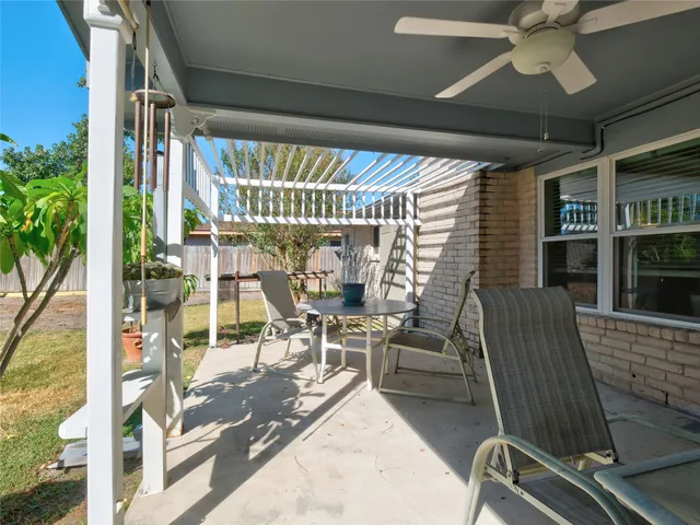 a work room with furniture and a potted plant