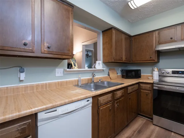 a kitchen with a sink cabinets and a window