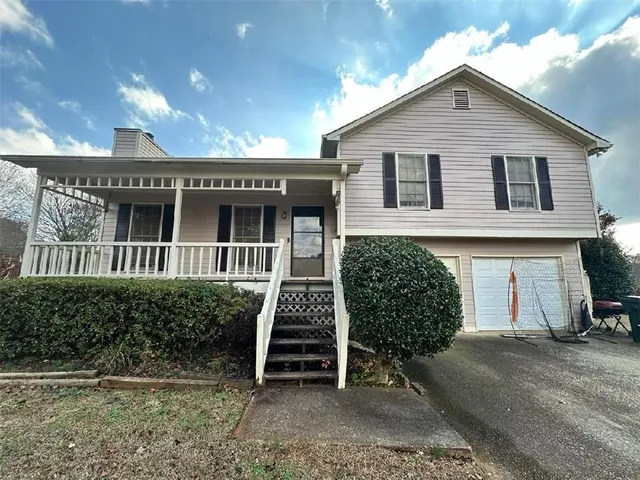 a front view of a house with a garden