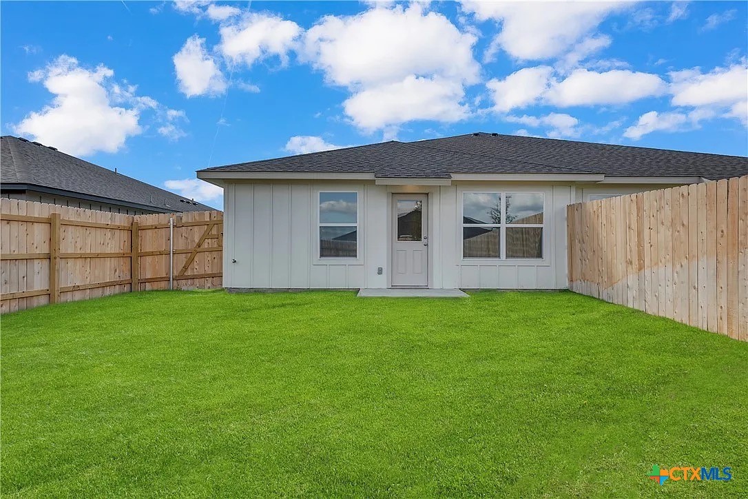 908 Smoke Tree Lane, Unit B Killeen, TX 76543 - Photo 12 of 13 a view of a backyard with potted plants and large tree