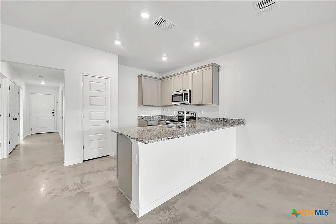 908 Smoke Tree Lane, Unit B Killeen, TX 76543 - Photo 2 of 13 a view of a bathroom with a sink mirror and shower