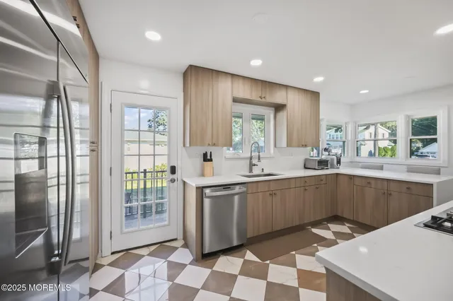 a kitchen with a sink a stove a refrigerator and cabinets