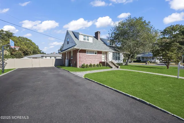 a view of a big house with a big yard and potted plants