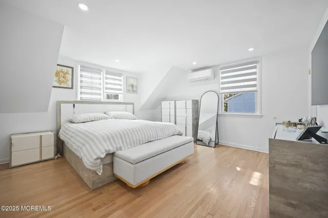 a spacious bedroom with a bed and a couch