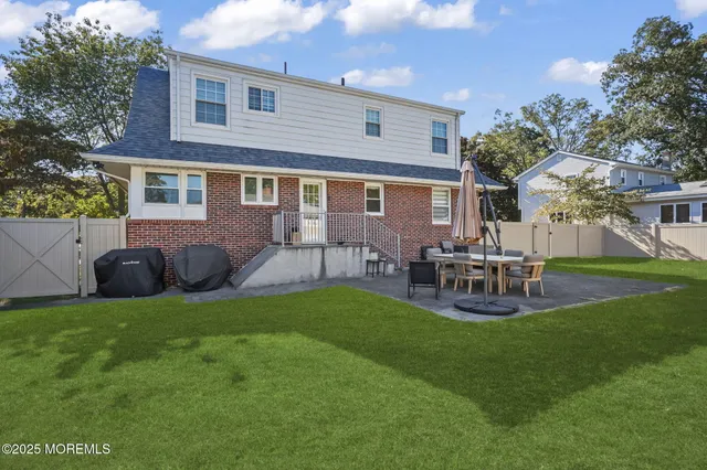 a view of a house with backyard porch and sitting area
