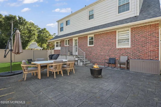 a view of a patio with table and chairs