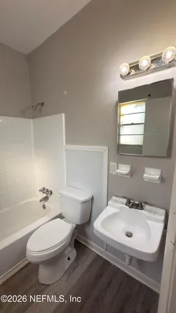 a white toilet sitting next to a bathroom sink