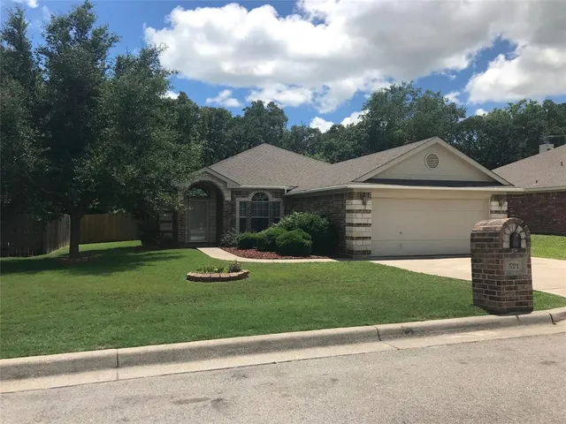 a front view of a house with a garden and area