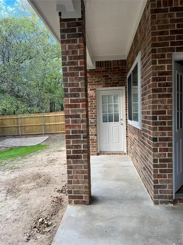 a view of a pathway to a house with backyard