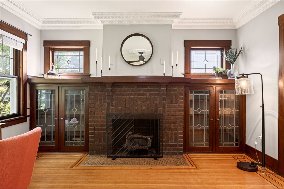 29 Elmcroft Road Rochester, NY 14609 - Photo 7 of 42 Brick gas fireplace is flanked by built-in shelvin