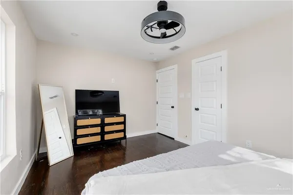 a bedroom with a bed and a chandelier
